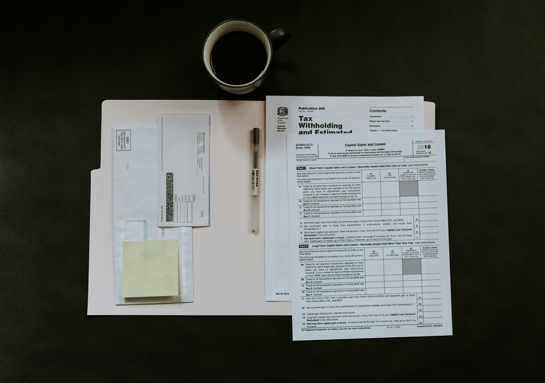 IRS tax returns in a folder with a cup of coffee