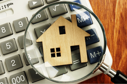 House on calculator with magnifying glass